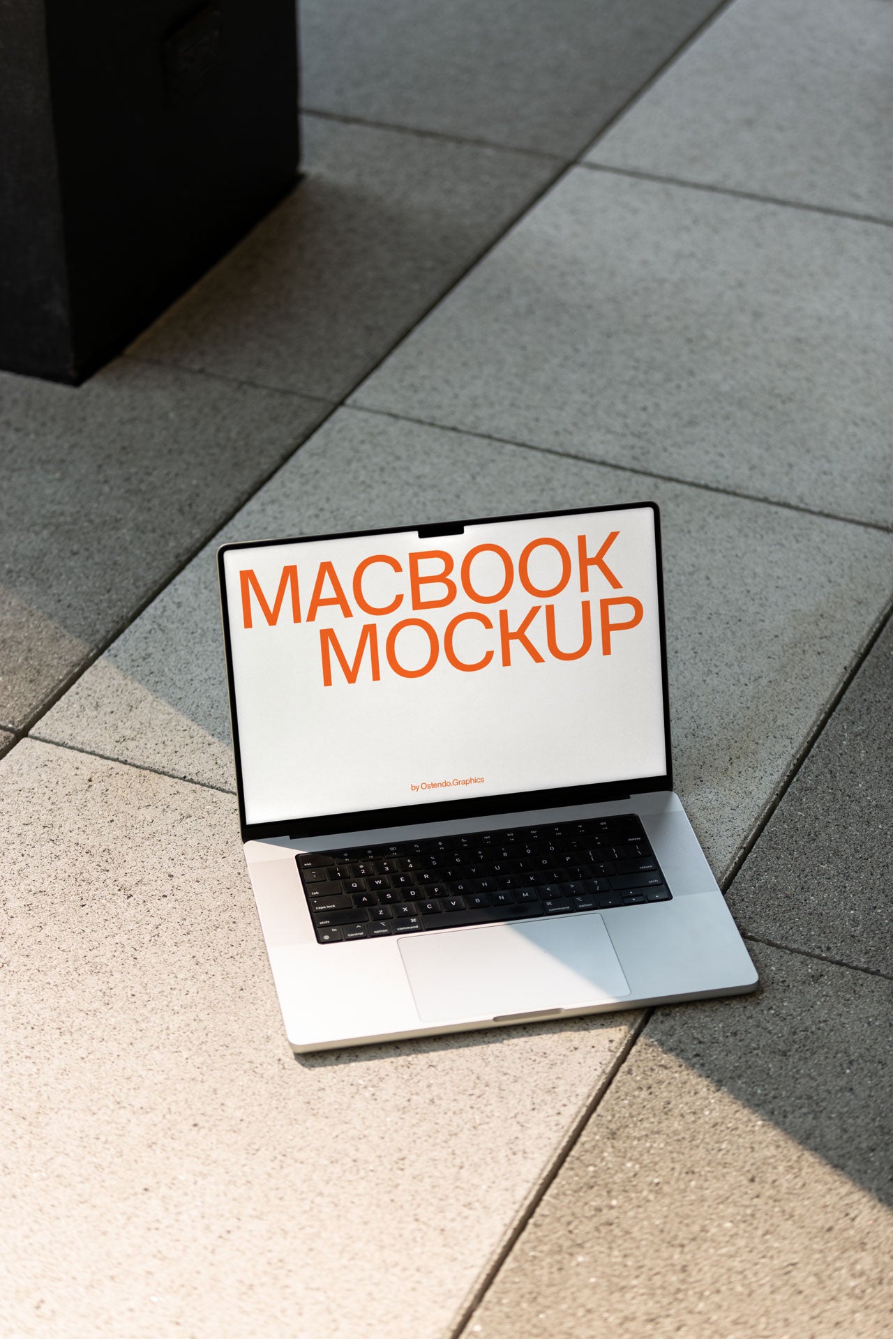 DD49 Macbook Pro Mockup on a Stone Sidewalk