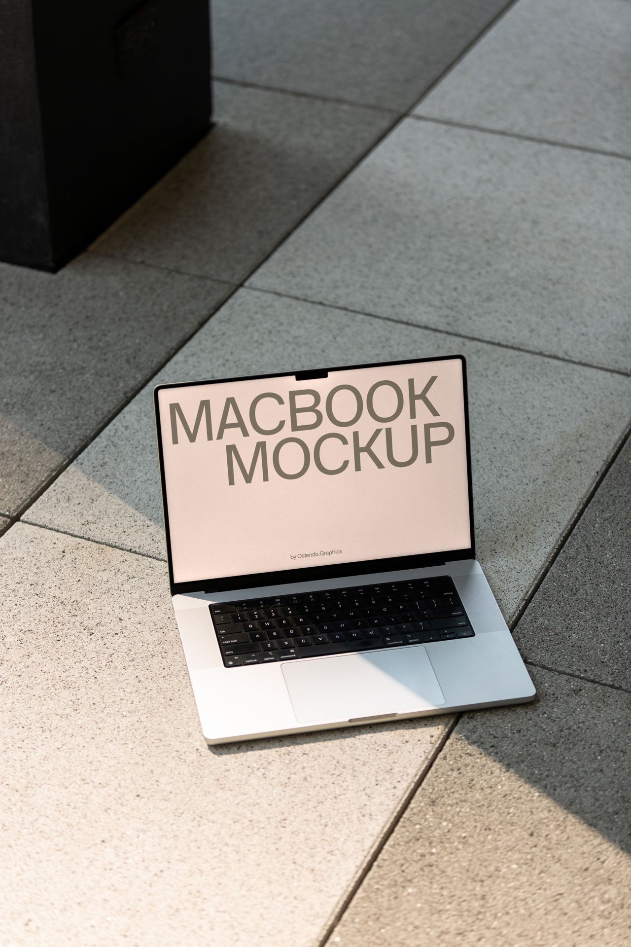DD49 Macbook Pro Mockup on a Stone Sidewalk