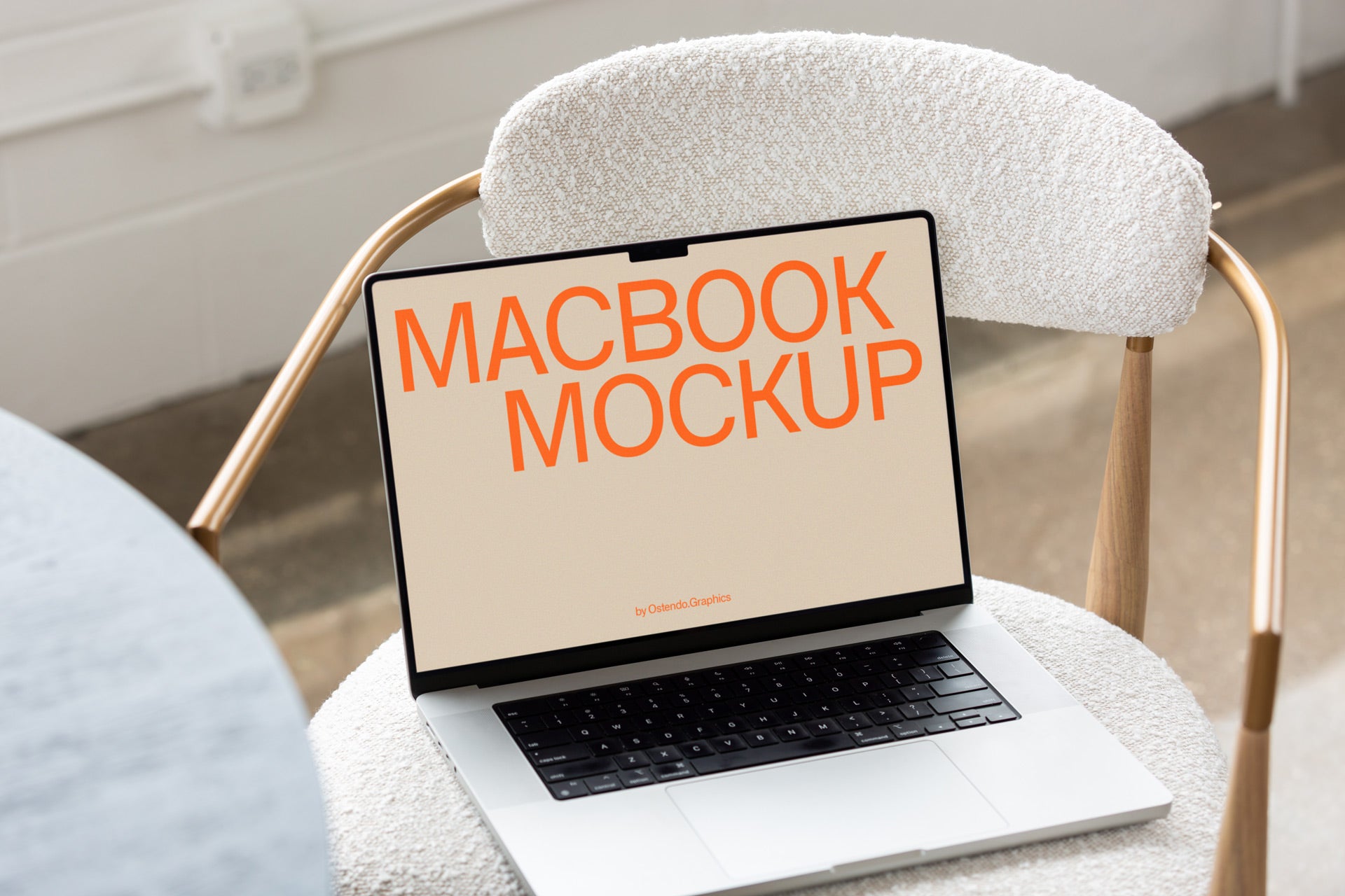 DD67 Macbook Pro Mockup on a White and Brass Chair – Ostendo.Graphics
